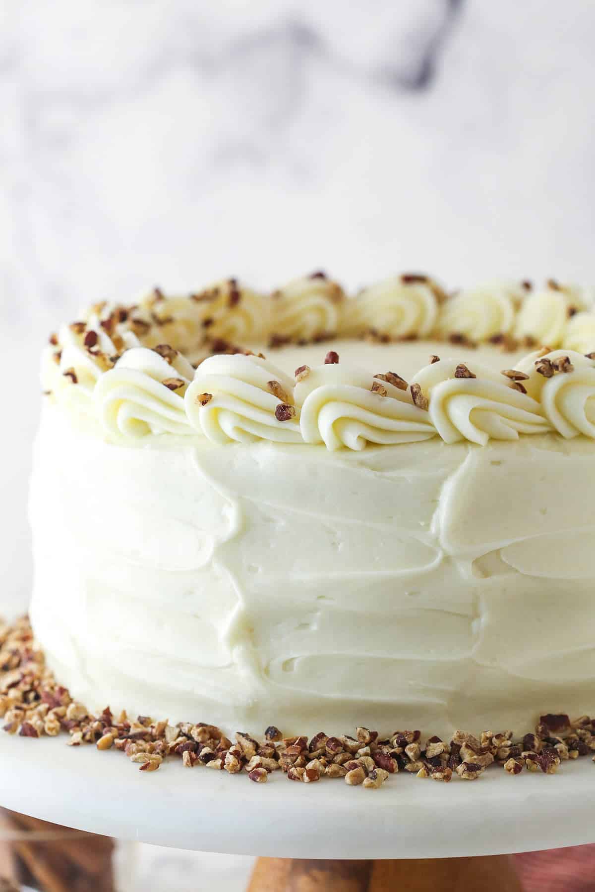 Close up of a spice cake on a white cake platter.