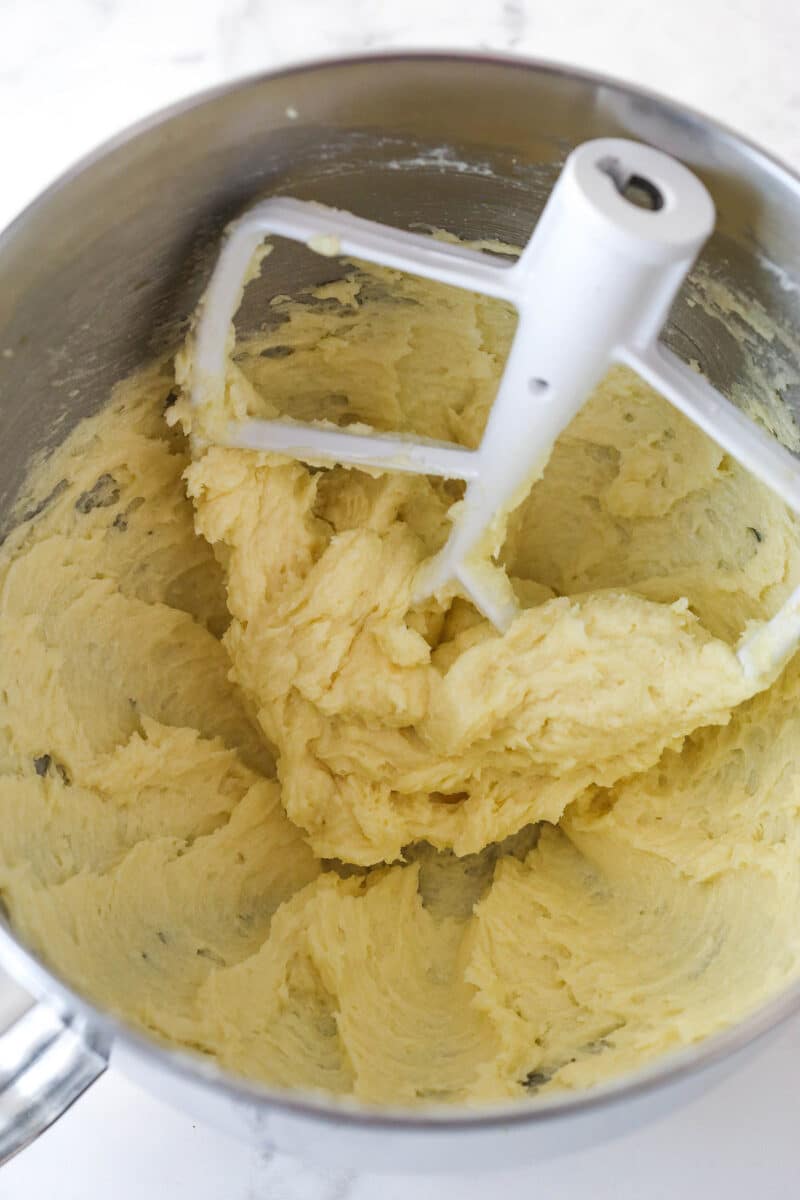 Adding eggs and vanilla to cookie bar dough.