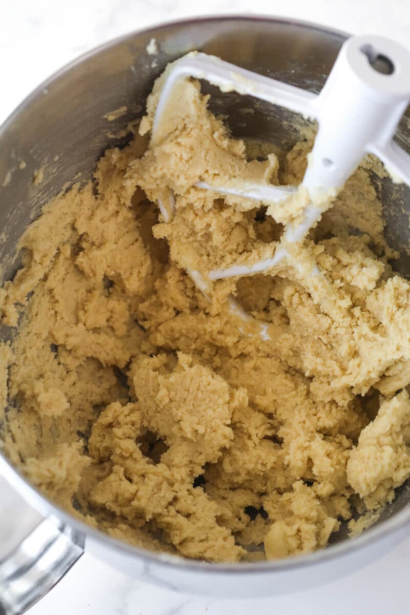 Mixing the dry ingredients into cookie bar dough.