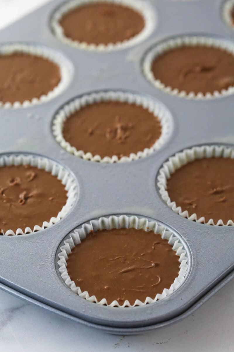 Chocolate cheesecake batter in cupcake liners.
