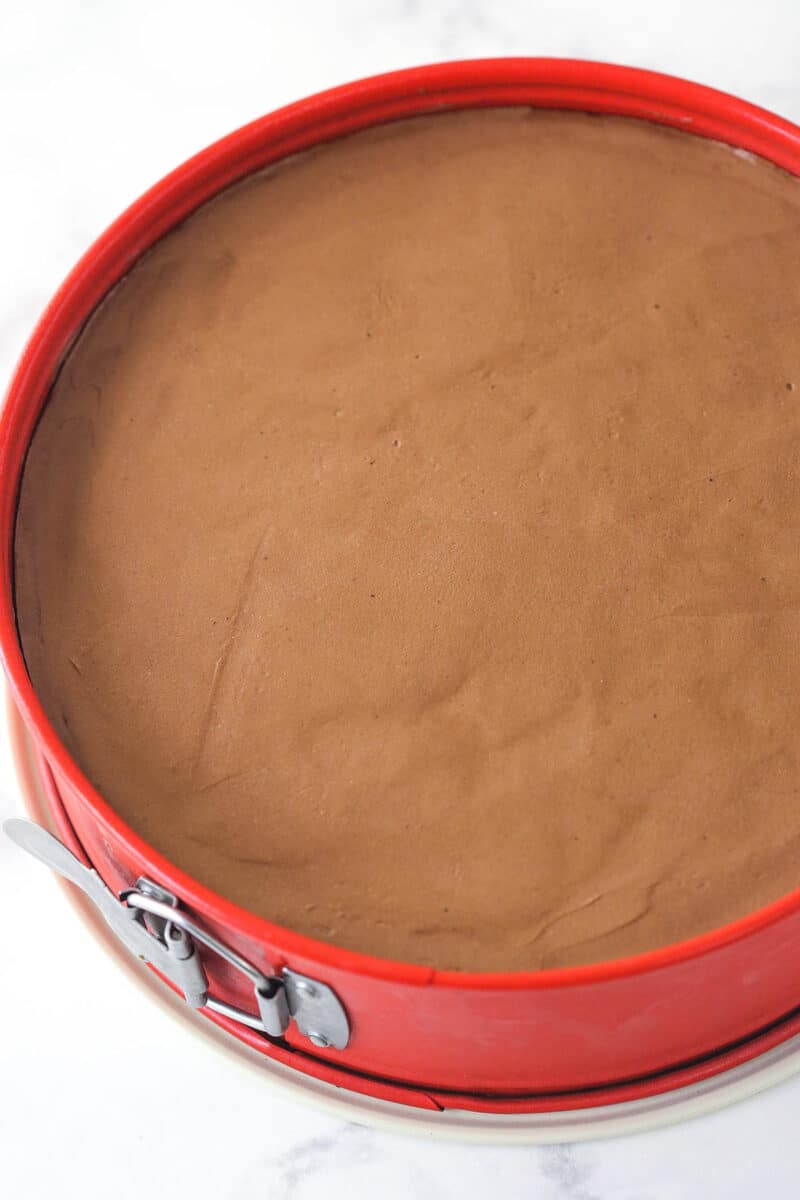 No-Bake Chocolate Cheesecake filling in a red springform pan.