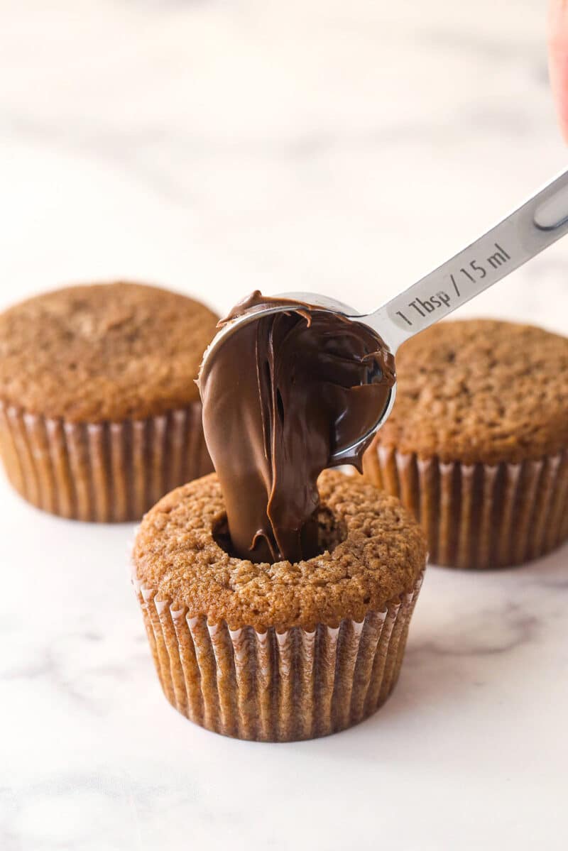 Filling a Nutella cupcake with Nutella.