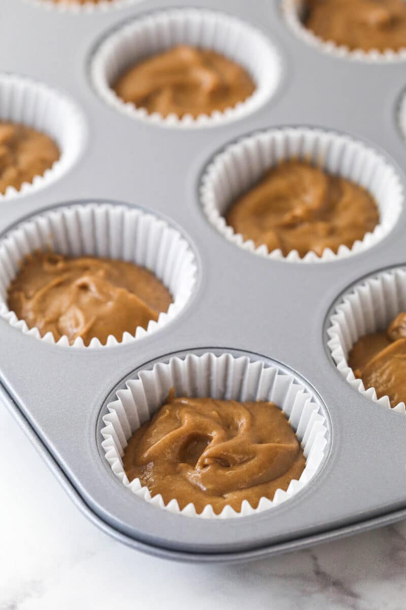 Nutella cupcake batter in cupcake liners in a cupcake pan.