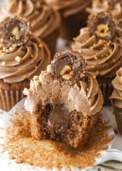 Nutella cupcakes on a serving platter. One has a bite taken out of it.