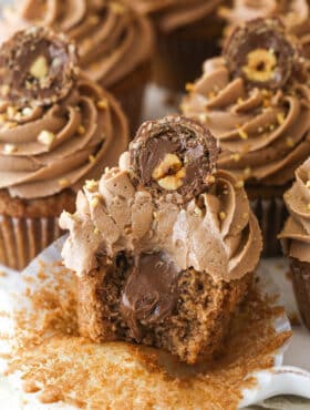 Nutella cupcakes on a serving platter. One has a bite taken out of it.