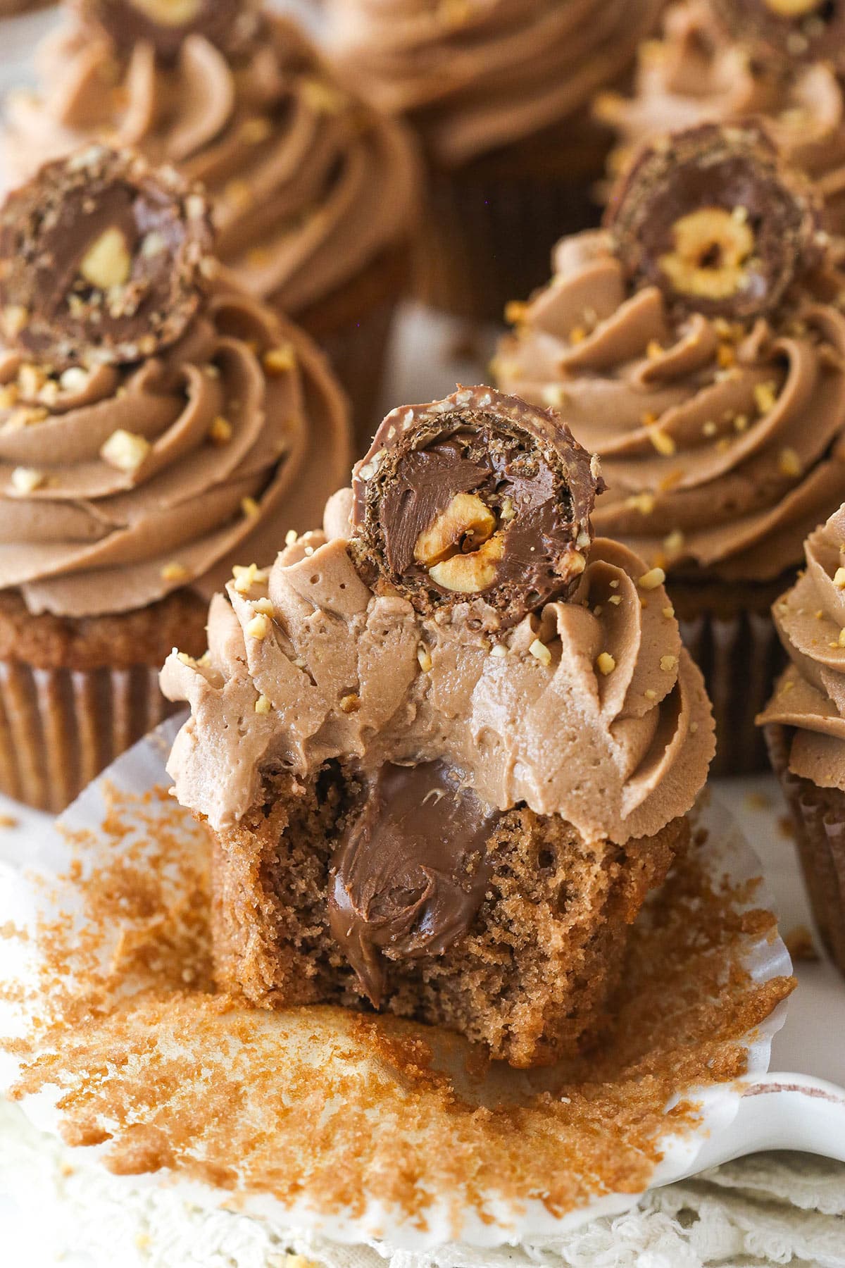 Nutella cupcakes on a serving platter. One has a bite taken out of it.