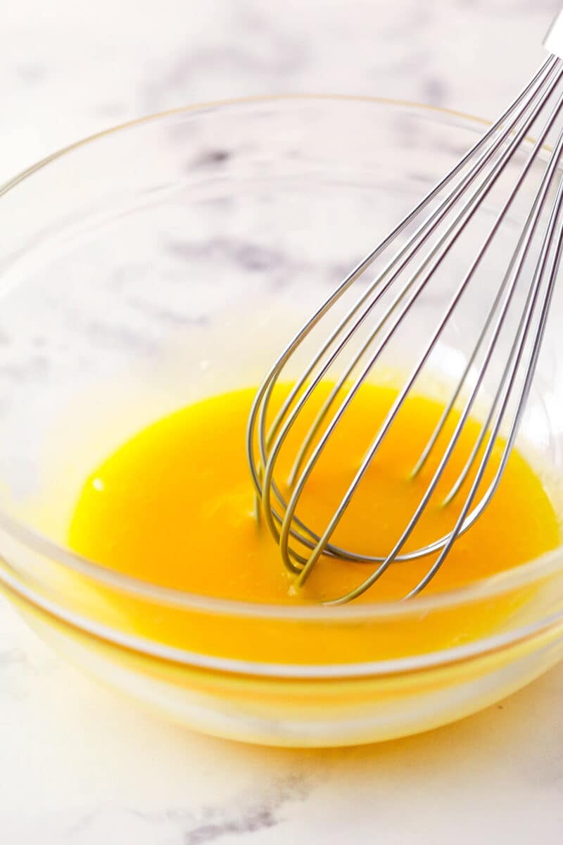 Whisk egg yolks in a bowl.