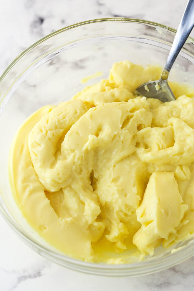 Stirring lumpy pastry cream in a bowl.