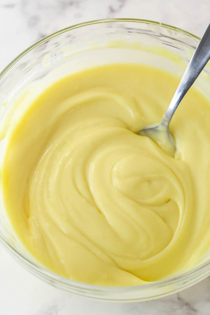 Stirring smooth pastry cream in a bowl.