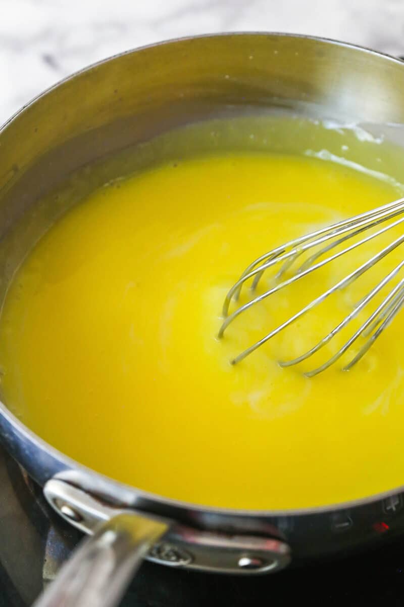 Whisking tempered egg yolks into pastry cream.