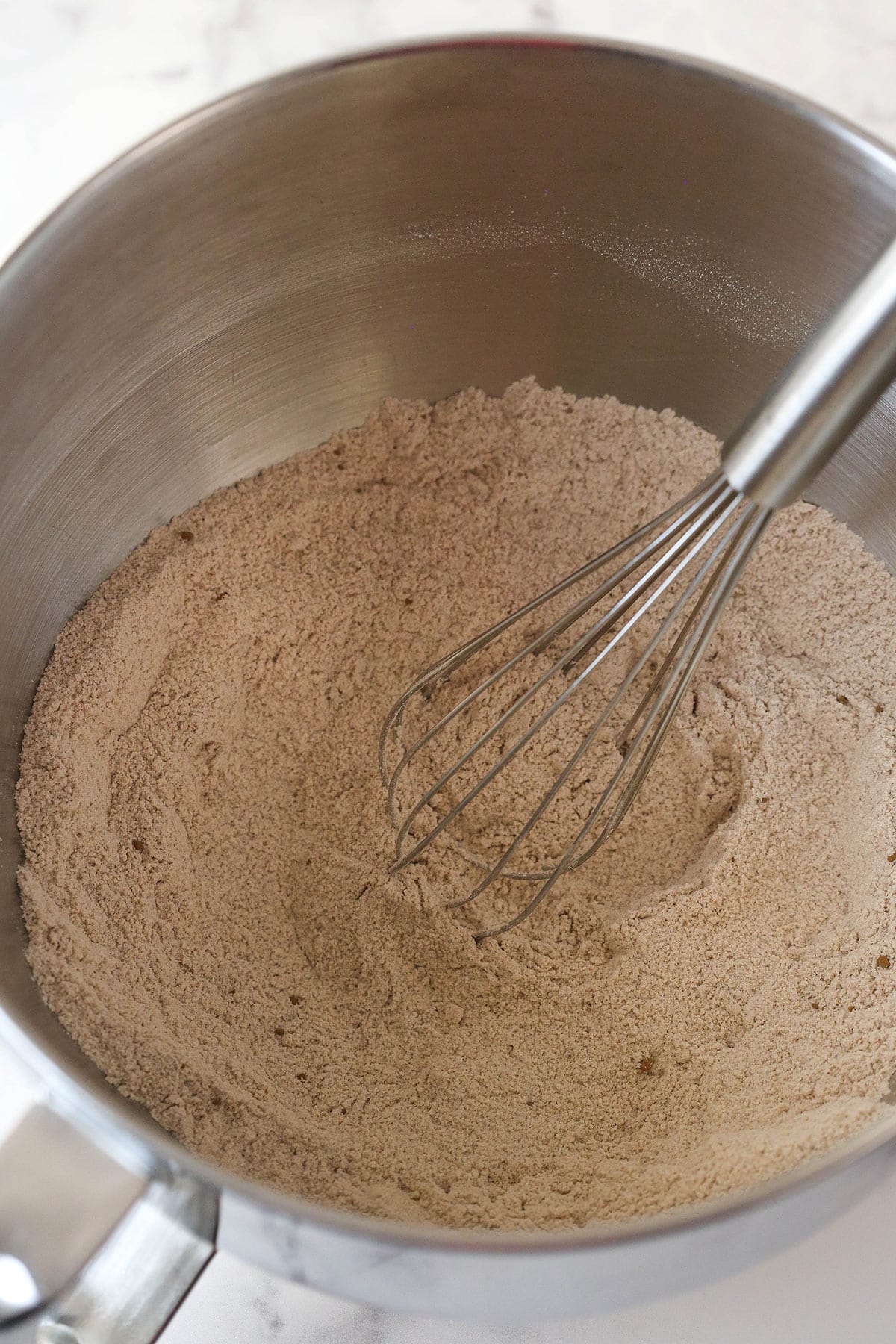 Whisking together the dry ingredients for red velvet cupcake batter.