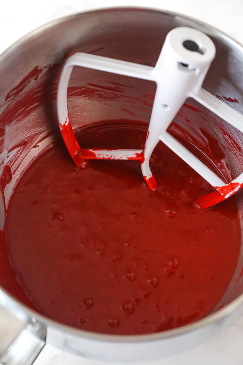 Combining wet and dry ingredients for red velvet cupcake batter.