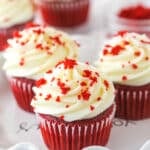 Red velvet cupcakes garnished with red velvet crumbles.