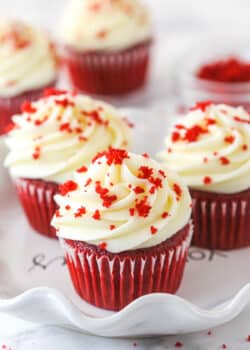 Red velvet cupcakes garnished with red velvet crumbles.