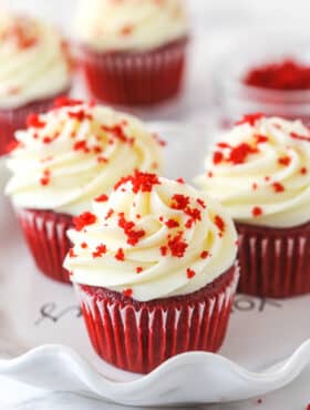 Red velvet cupcakes garnished with red velvet crumbles.