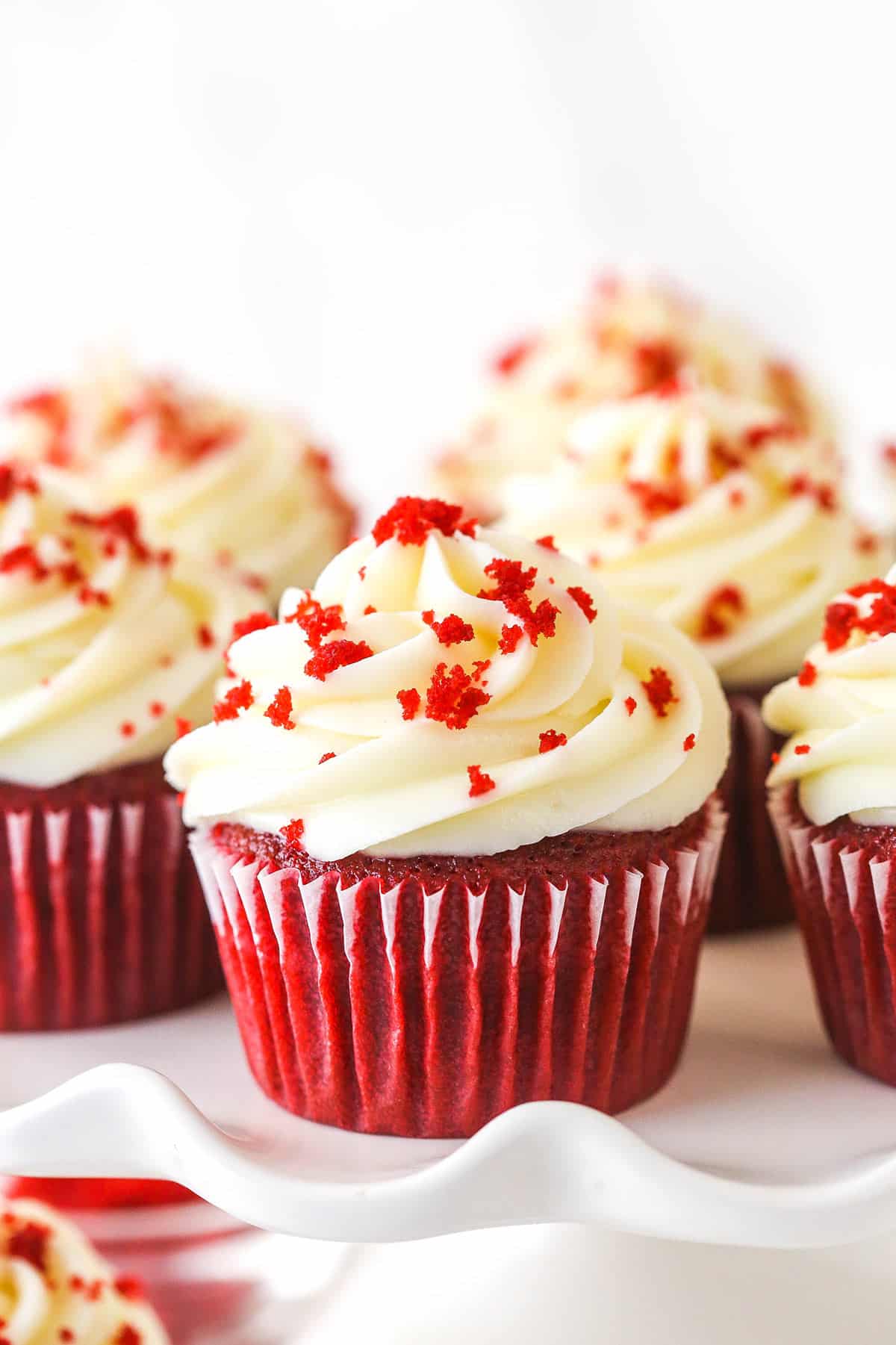 Closeup of red velvet cupcakes on a serving platter.