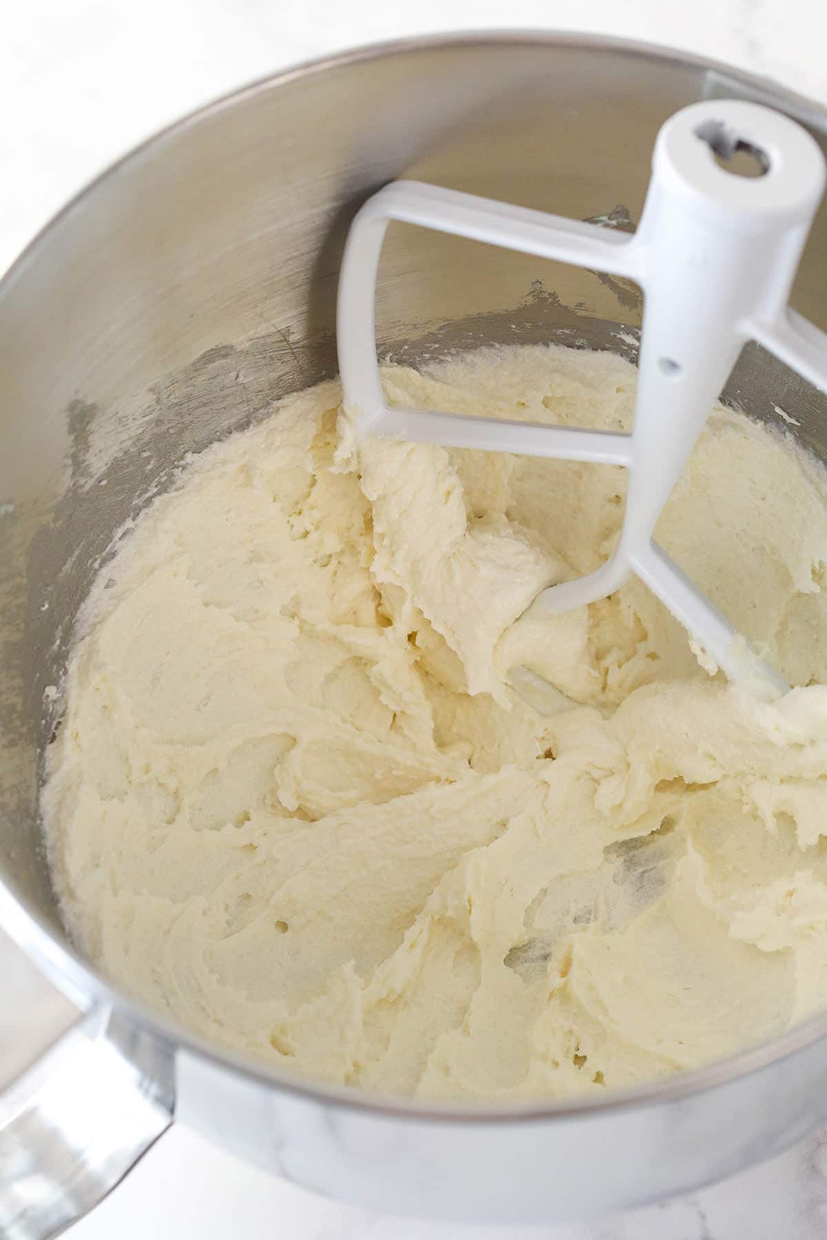 Overhead view of butter, sugar, oil and vanilla extract combined in a large mixing bowl