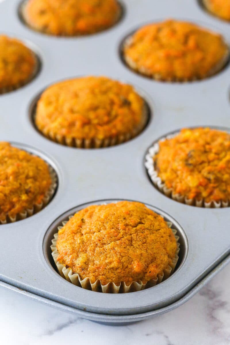 Carrot cake cupcakes in the cake pan sans frosting.