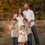 whole family standing by pond