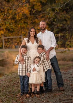 whole family standing by pond