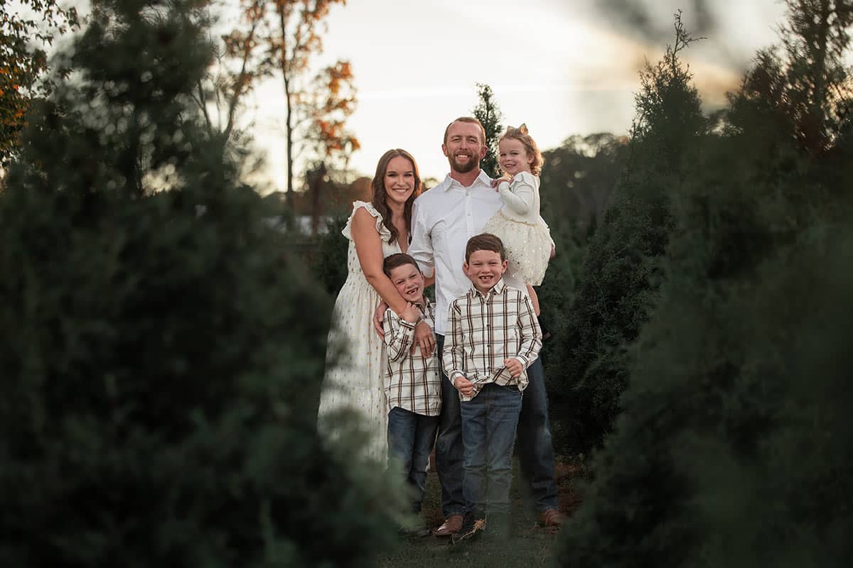 whole family among the Christmas trees