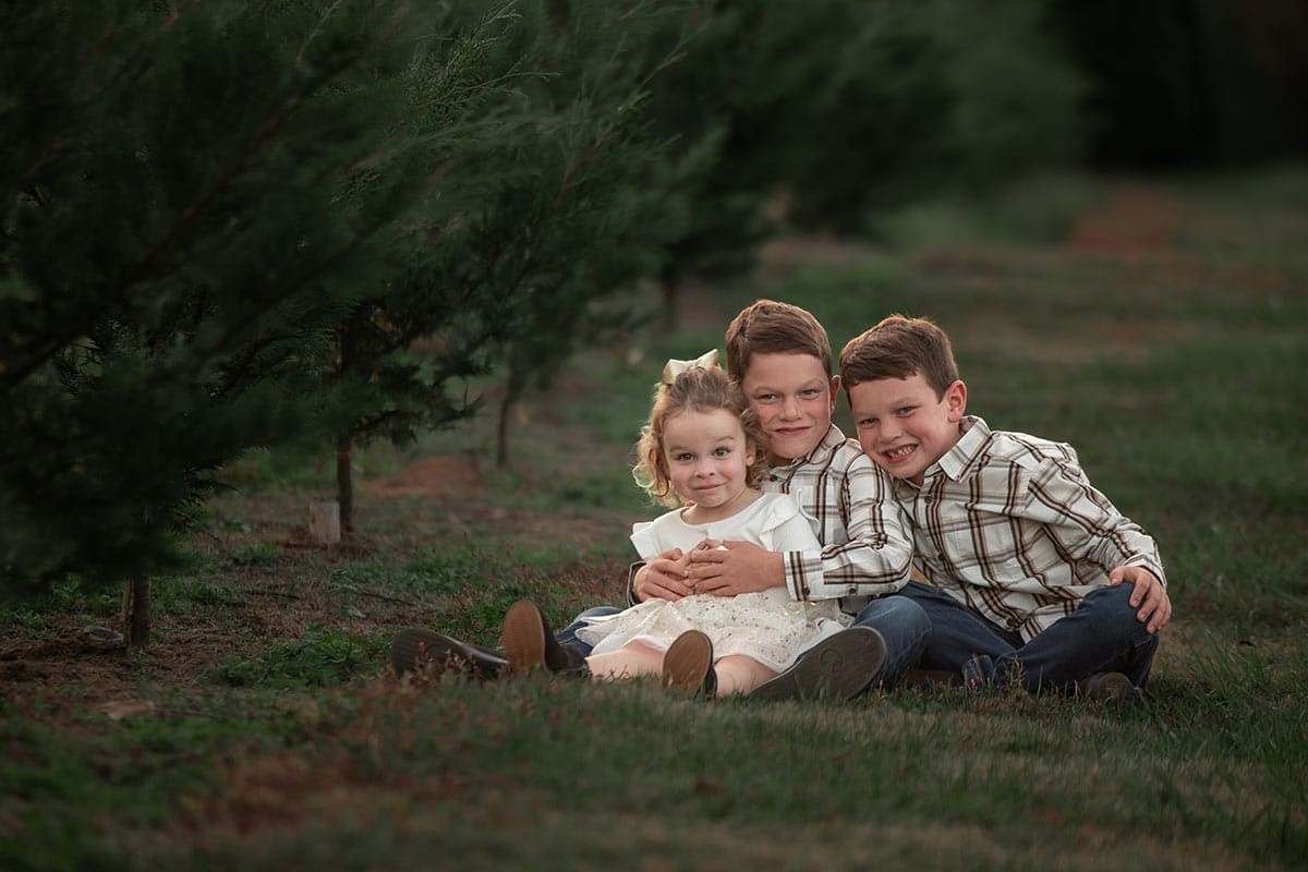 kids sitting on ground, McKenzie with silly face