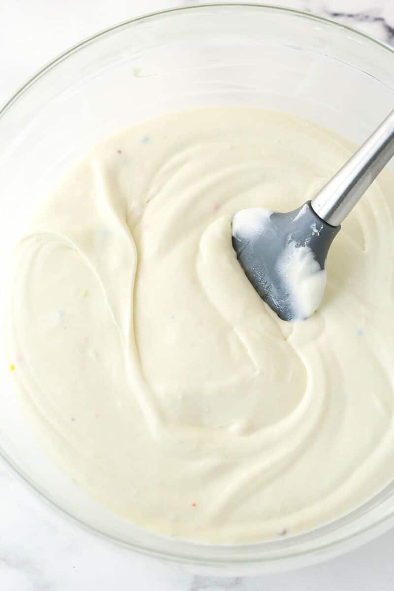 Folding whipped cream into birthday cake ice cream base.