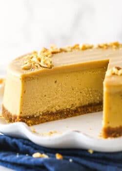 Peanut butter cheesecake with a slice taken out of it.