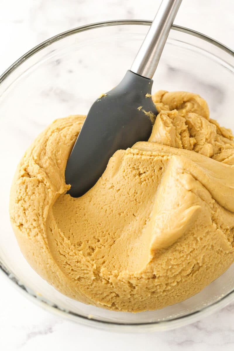 Mixing sweetened condensed milk into peanut butter fudge.