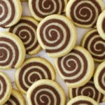 Overhead image of pinwheel cookies spread over a work surface.