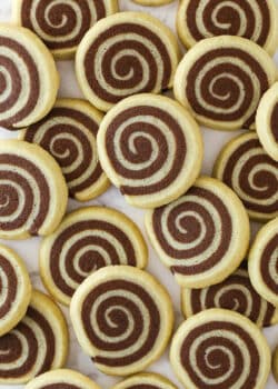 Overhead image of pinwheel cookies spread over a work surface.