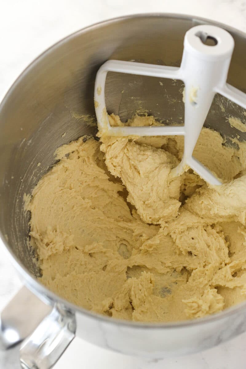 Creaming together butter and sugars for cookie cake.