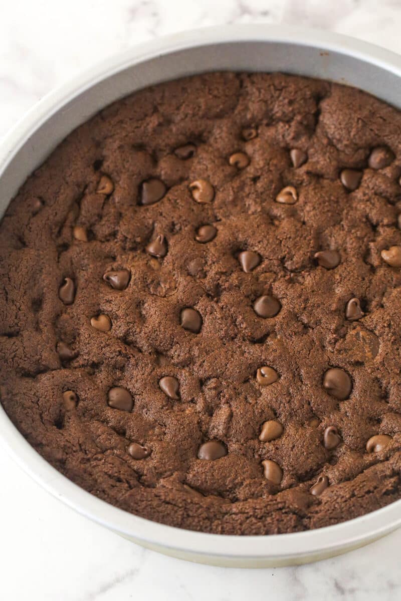 Chocolate cookie cake cooling in a cake pan.