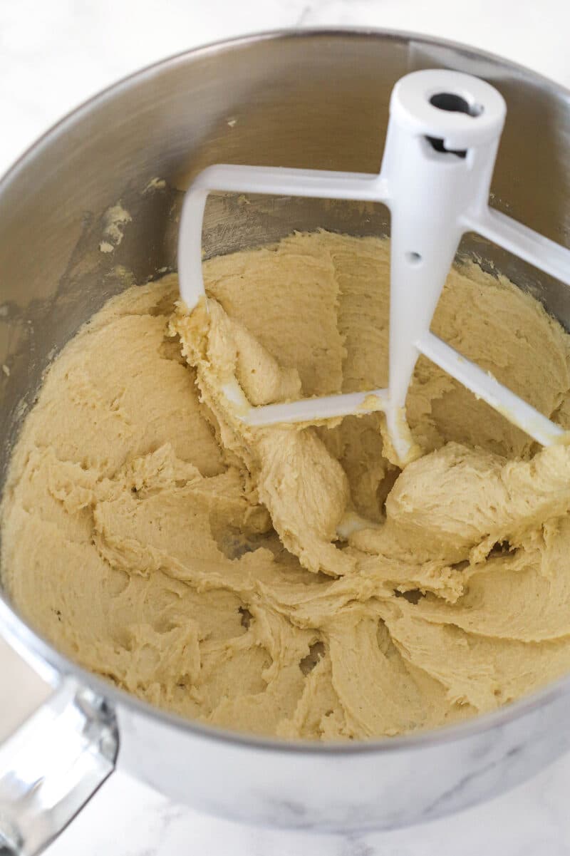 Creaming together butter and sugars to make cookie dough.