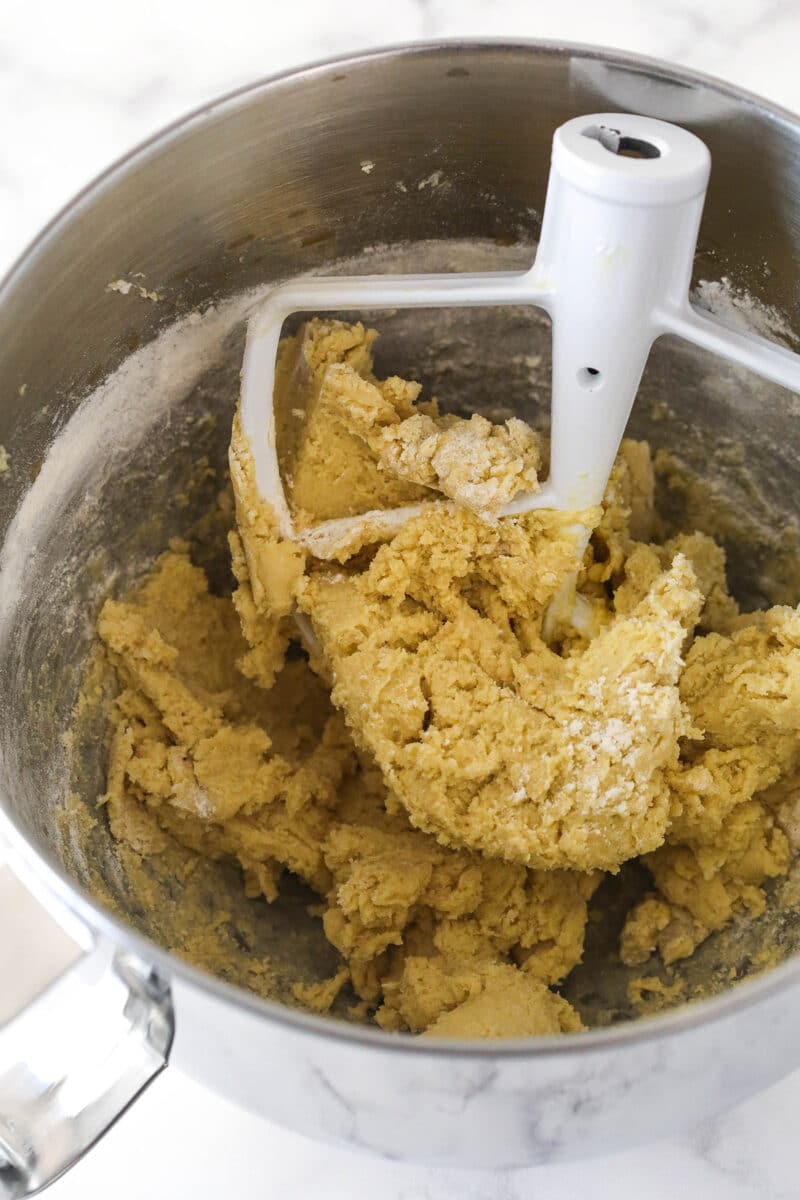 Mixing dry ingredients into the wet ingredients for cookie dough.