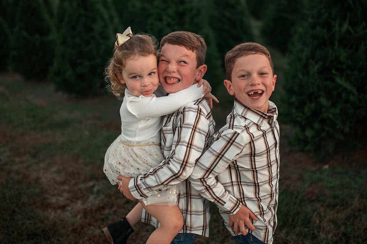 Boys smiling, holding mcKenzie