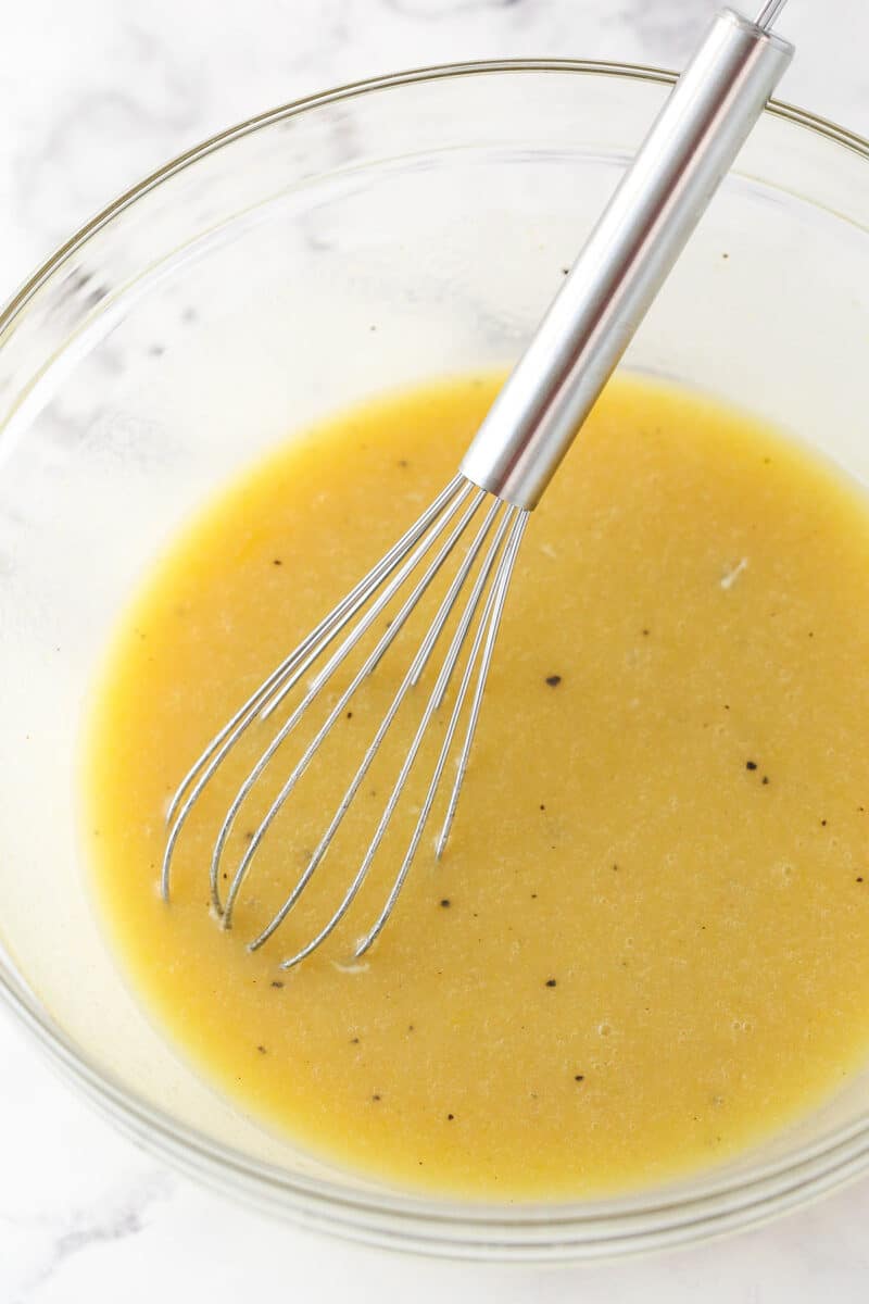 Mixing melted butter and eggs into the wet ingredients for brownie batter.