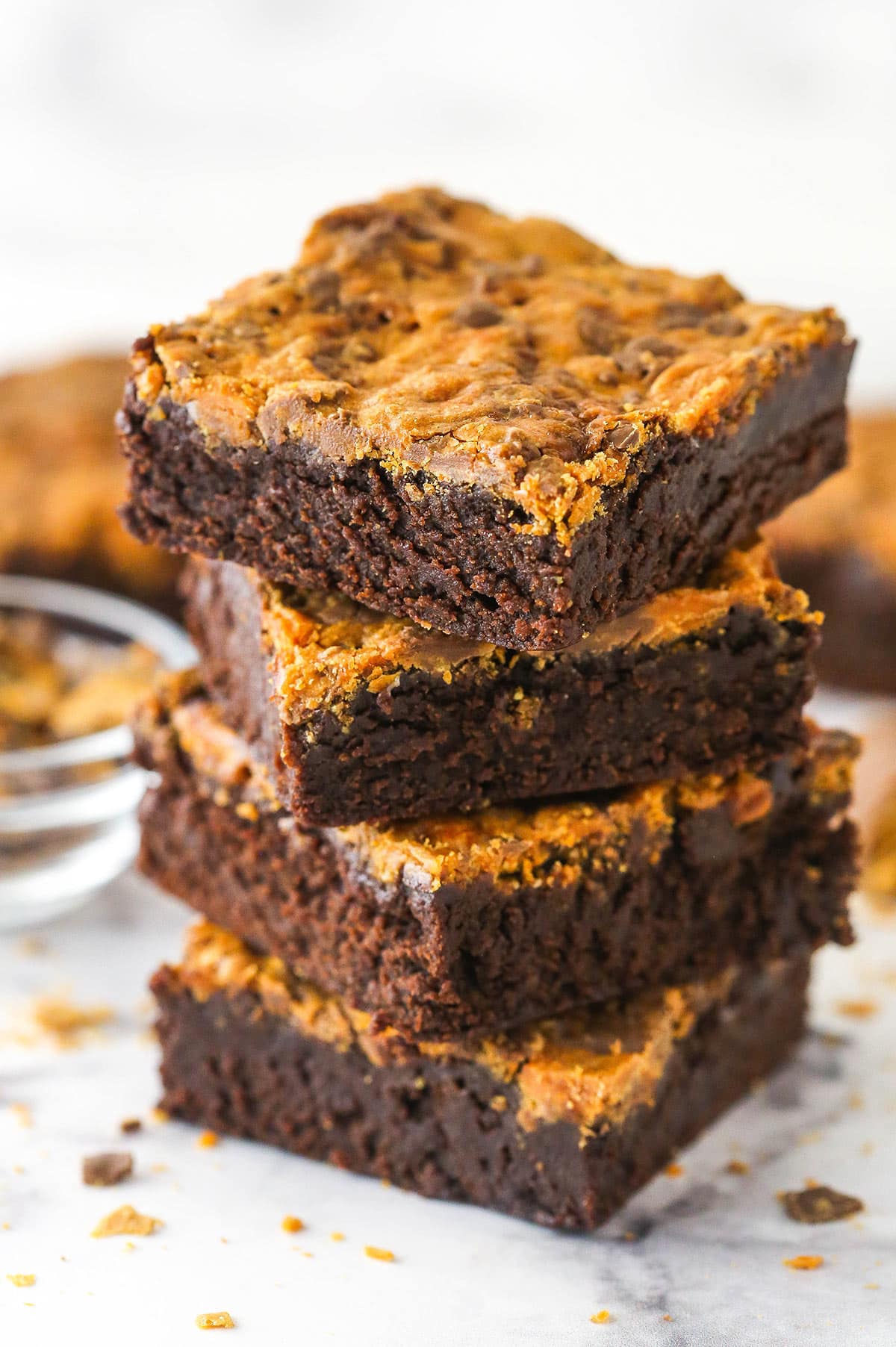 Butterfinger brownies strike the perfect balance between fudgy and cakey and are topped with crunchy, subtly peanut buttery Butterfingers. A stack of butterfinger brownies.