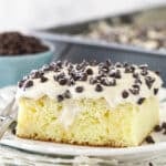 A slice of cannoli poke cake served on a plate.