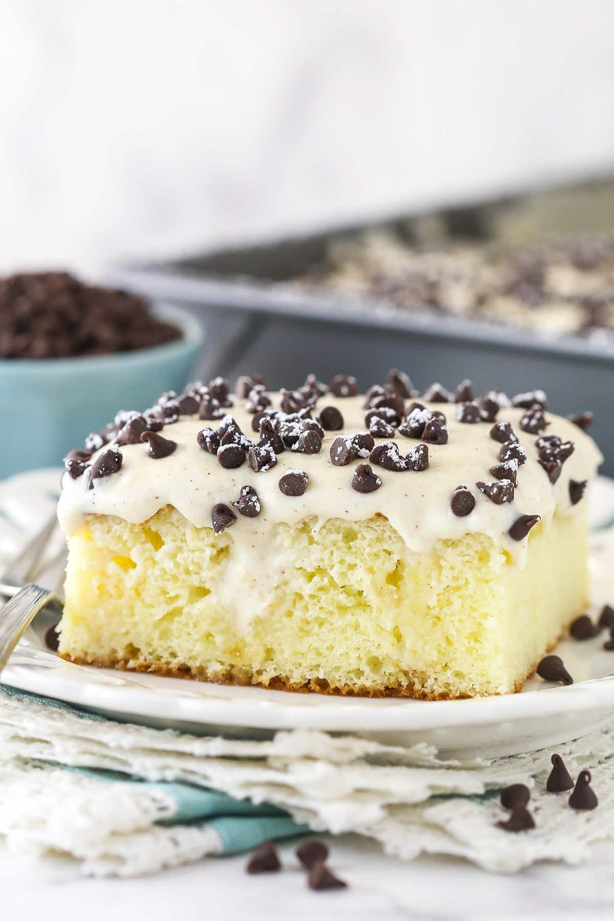 A slice of cannoli poke cake served on a plate.