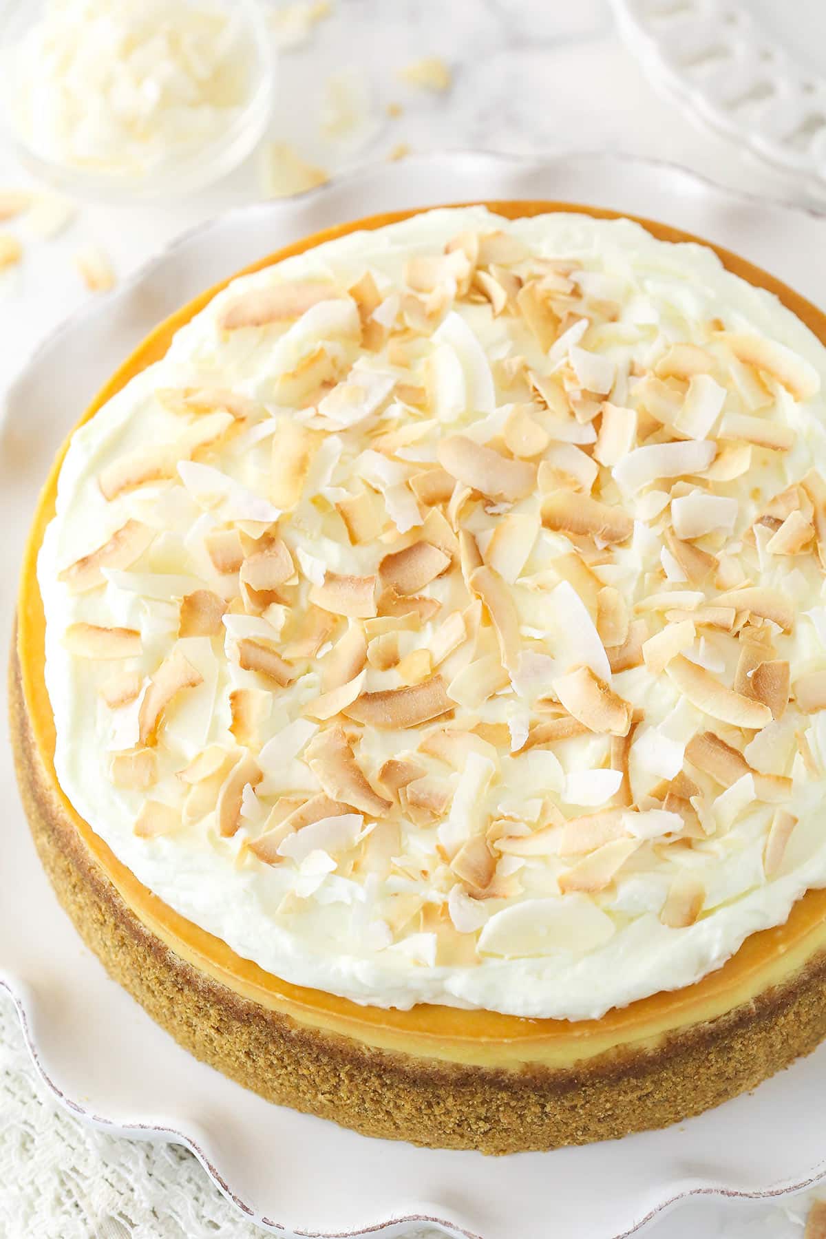 Overhead image of coconut cheesecake on a serving platter.