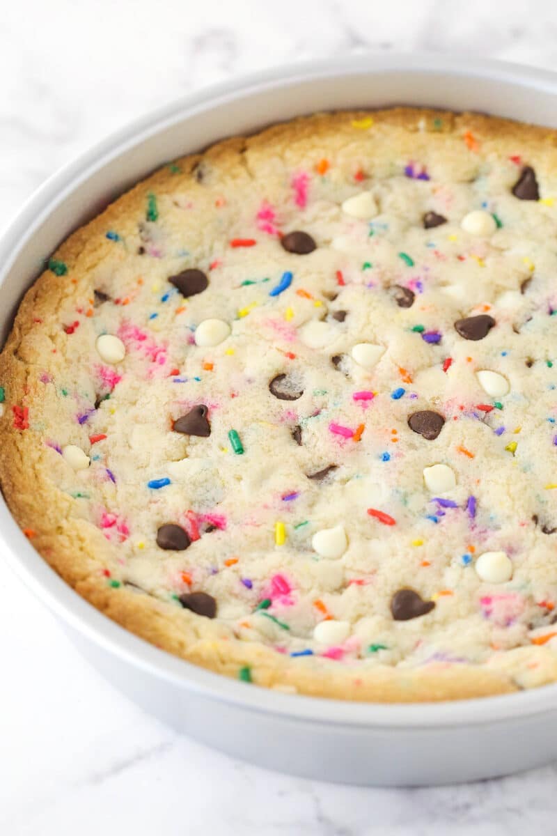 Funfetti cookie cake cooling in a cake pan.