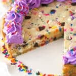 Overhead image of Funfetti cookie cake with a slice taken out of it.