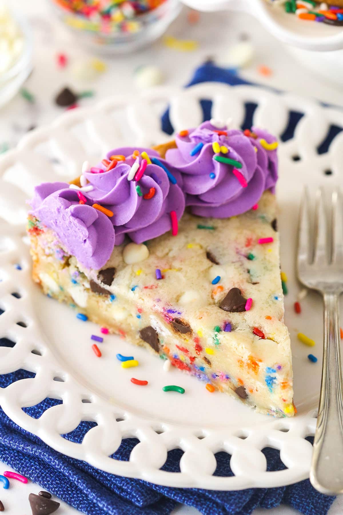 A slice of Funfetti cookie cake on a plate.