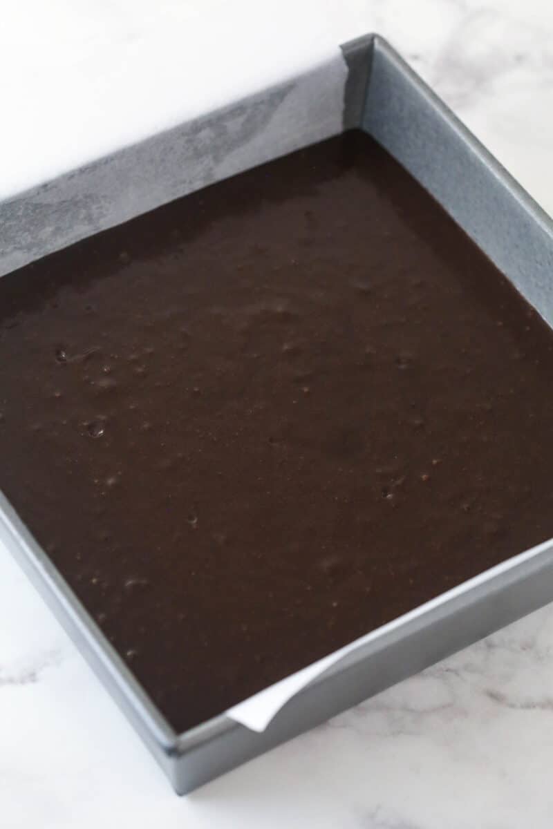 Guinness brownie batter in a baking pan.