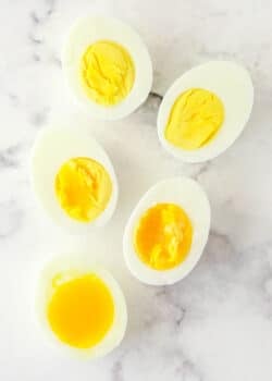 Overhead image of eggs boiled to varying levels of doneness.