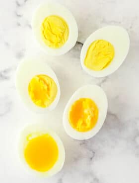 Overhead image of eggs boiled to varying levels of doneness.