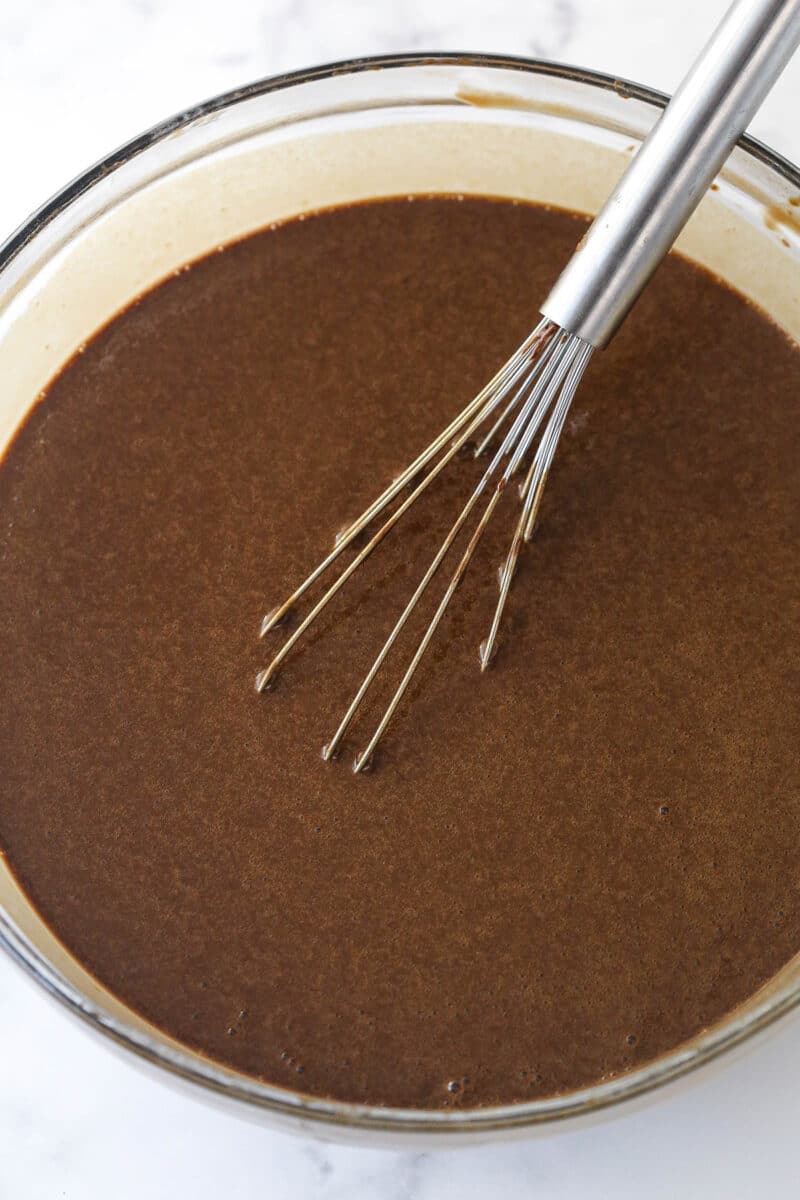 Mix vanilla and hot water into chocolate cake batter.