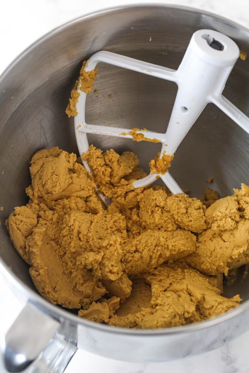 Beating together Cream cheese, powdered sugar, and peanut butter.