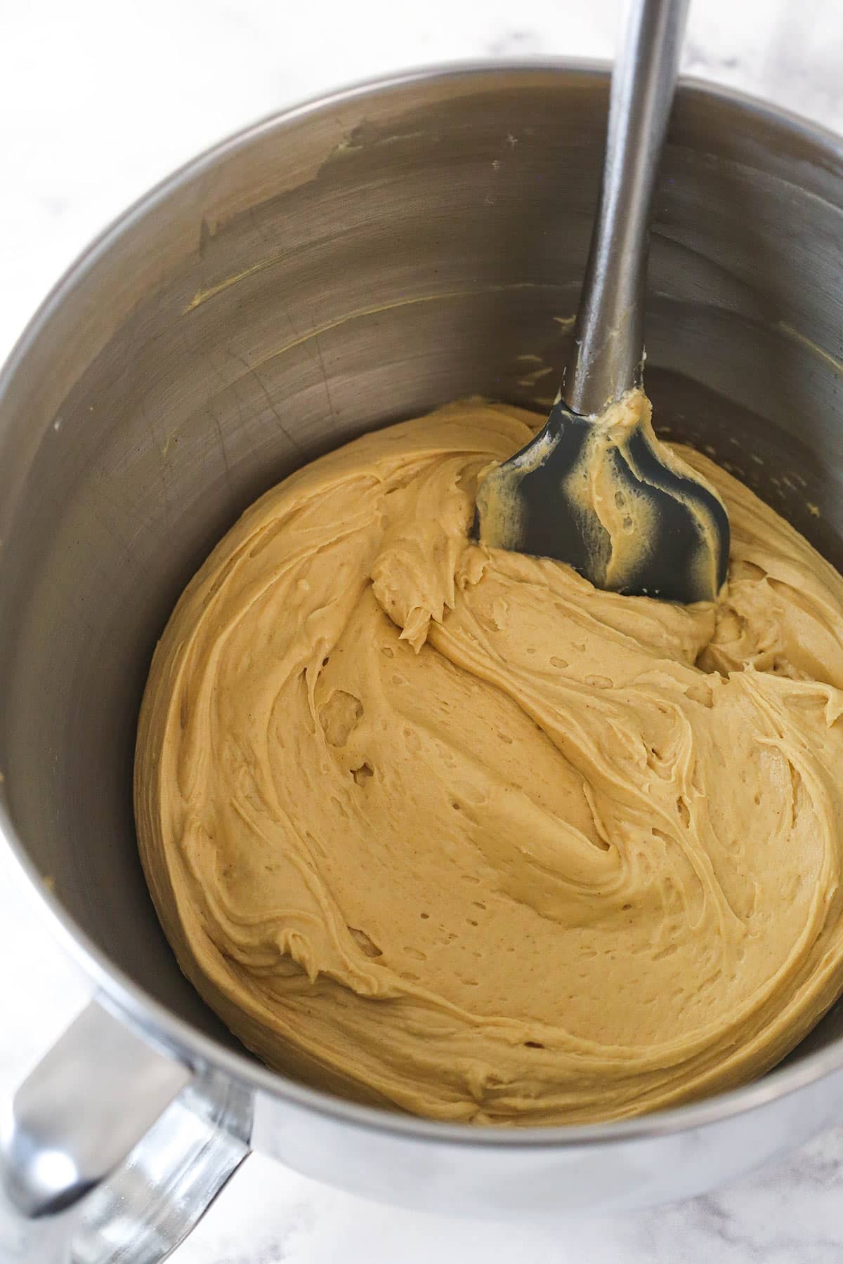 Folding whipped cream into peanut butter pie filling base.